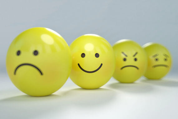 Yellow balls with faces displaying different emotions