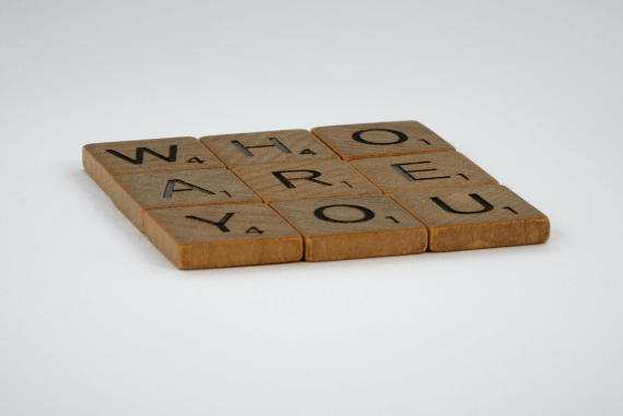 Brown tiles spelling out the phrase who are you