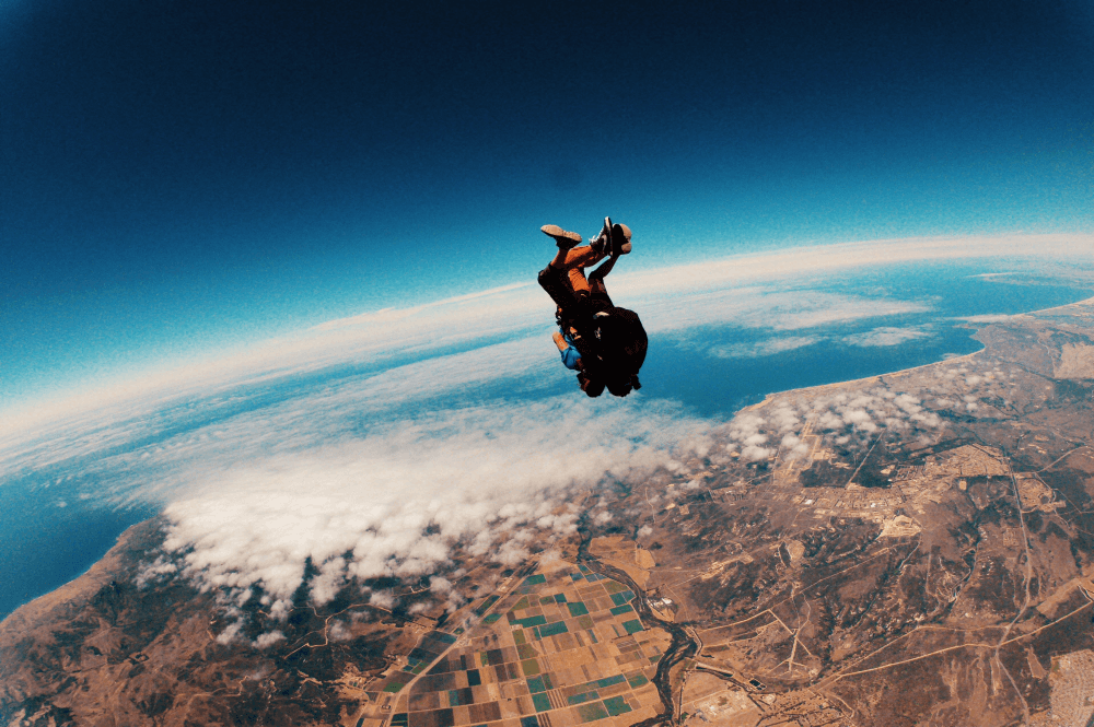 A skydiver falling forwards back to the ground