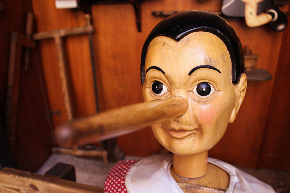 A wooden puppet with a long nose to signify lying