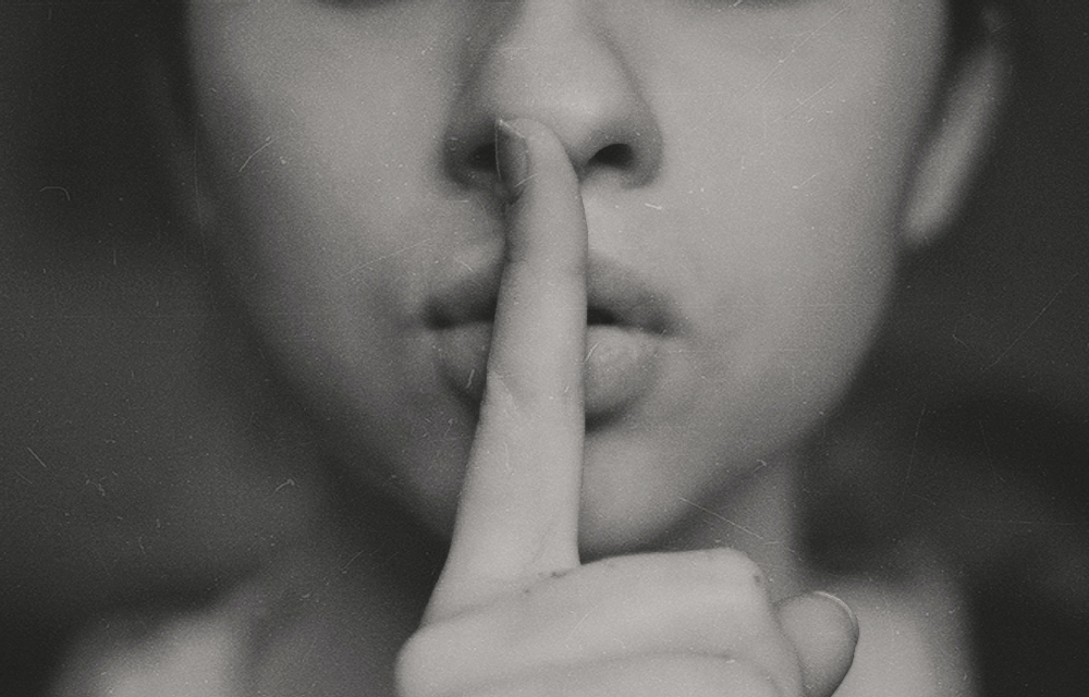 Finger to lips representing quiet