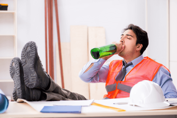 A drunk employee drinking alcohol when at work
