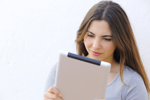 A young woman reading an e-book