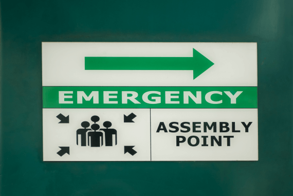 An emergency assembly area sign