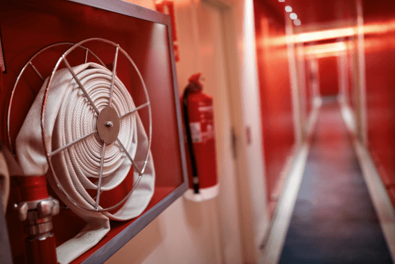 A fire hose on a reel in a building