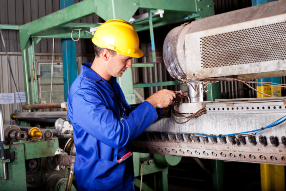 An engineer performing maintenance on machinery