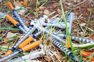 Hypodermic needles on the ground outdoors