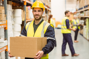 Warehouse worker manual handling with box